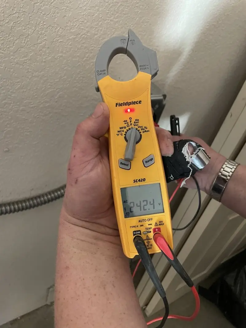 Voltage testing with clamp meter during Generator Installation in Bethel Manor